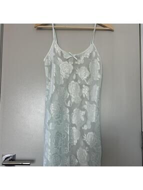 White lace slip dress with floral embroidery and bow detail